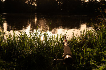 Fishing rod on the background of the lake in the evening.の写真素材