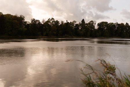 Landscape photo of a lake in the forest on a cloudy dayの写真素材
