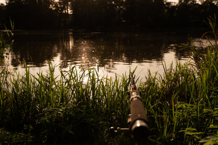 Fishing rod on the background of the river in the evening.の写真素材
