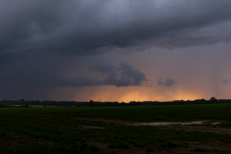 Rain clouds over the field in the evening, natural landscape background.の写真素材