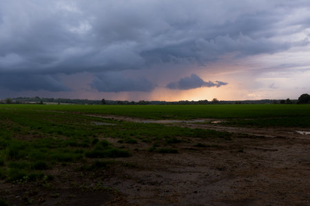 Storm clouds over a field in the countryside of North Polandの写真素材