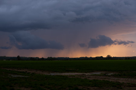 Rain clouds in the evening over the field in the countryside of Polandの写真素材