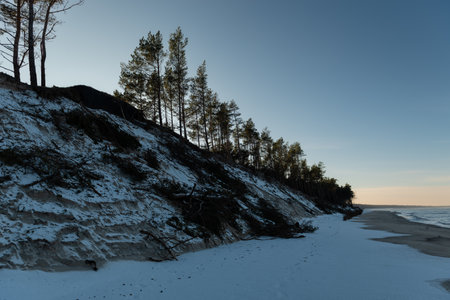 Baltic sea shore in winter at sunset. Beautiful winter landscape.の写真素材