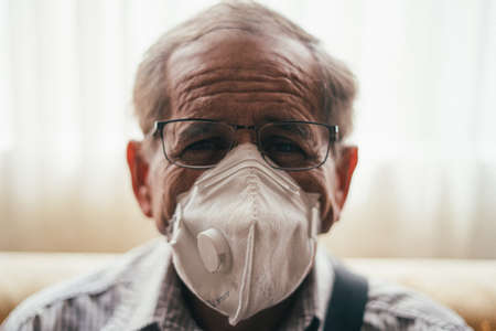 Old man working in pandemic quarantineの写真素材