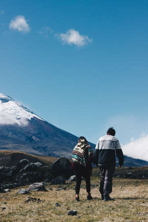 Beautiful couple walking to the mountainの写真素材