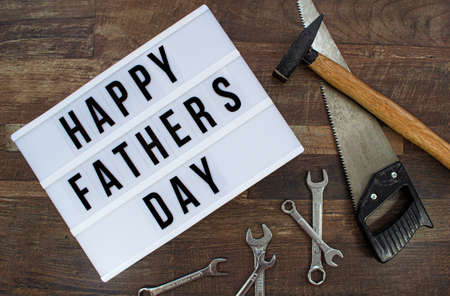Happy Father's Day background with Various tools on a wooden background, Top view.