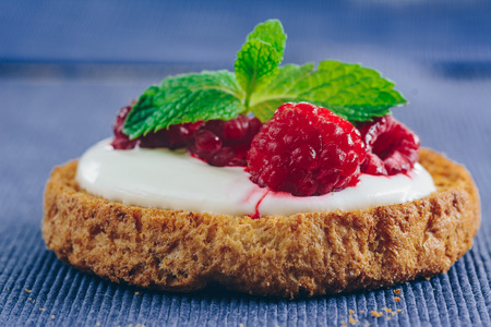 Whole grain rusk with raspberry and sweet creamの写真素材