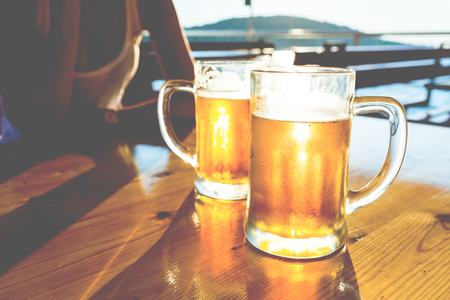 two beers in sunsetの写真素材