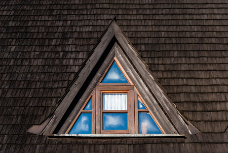 Triangular wooden skylight with glassの写真素材