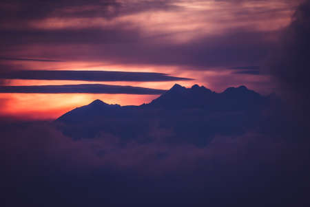 Dark mysterious mountain peaks shrouded in clouds, Tatra Mountains, Polandの写真素材