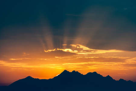Dark mountain peaks in the setting orange sun, Tatra Mountains, Polandの写真素材