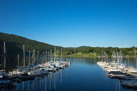 View to the german lake called Edersee with sailing boatsの写真素材