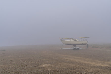 The dry lake Edersee with boat near the tiny village Rehbachの写真素材