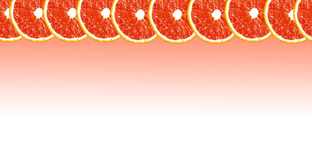 Grapefruit halves background with space for text on a white backgroundの写真素材