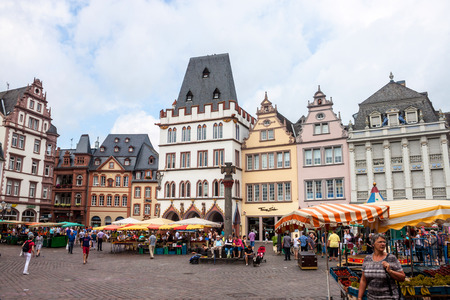 TRIER, GERMANY- AUGUST 3: People and stalls at Market square in Trier, Germany, on August 3, 2013. Trier is the oldest city in Germany, founded in 16 BC.のeditorial素材