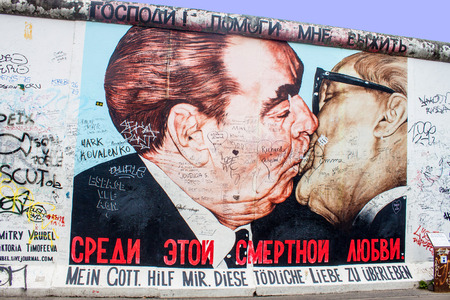 BERLIN - JUN 8: Kiss between Brezhnev and Honecker at East Side Gallery on Jun 8, 2013 in Berlin, Germany. It is a 1,3 km long part of original Berlin wall, famous memorial with many grafittis.のeditorial素材