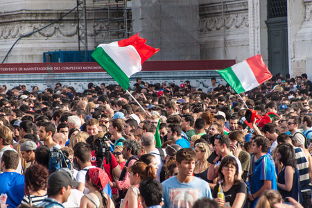 ROME, ITALY - JUNE 24: Crowd of football fans in front of Famous Italian monument Vittorio Emanuele II in Rome, Italy on June 24, 2014. They watch the match Italy-Uruguay of the World Cup.のeditorial素材
