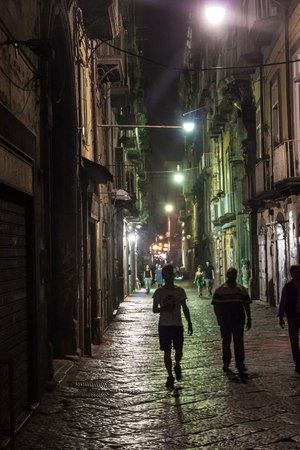 NAPLES, ITALY- JUNE 30, 2014: Night view of a street in historic center of Naples, Italy. Naples historic city center is the largest in Europe.のeditorial素材