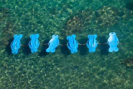 Floating deck chairs in a sea in Sorrento, Italyの写真素材