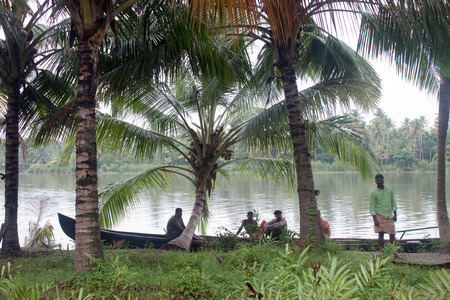BACKWATERS, INDIA - AUGUST 24: People in a canoe on August 24, 2011 in Backwaters, India. The Kerala Backwaters are a network of interconnected canals, rivers, lakes and inlets.のeditorial素材