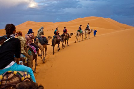 ERG CHEBBI, MOROCCO - AUGUST 3: Camel caravan with tourists in the desert on August 3, 2010 in Erg Chebbi, Morocco. Erg Chebbi is part of Sahara desert.のeditorial素材