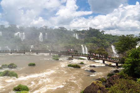 IGUACU, BRAZIL - FEB 5, 2015: Tourists admire Iguacu (Iguazu) falls on a border of Brazil and Argentinaのeditorial素材