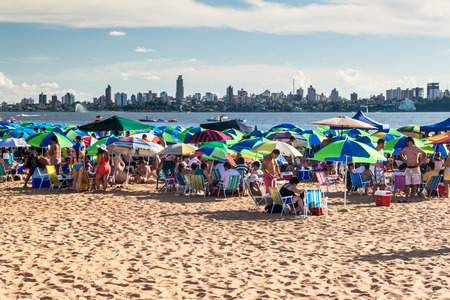 ENCARNACION, PARAGUAY - FEB 7, 2015: People on a beach at river Parana in Encarnacion city.のeditorial素材