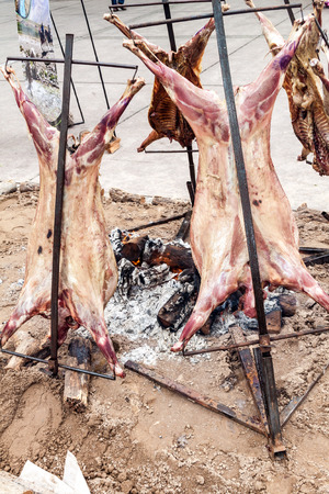 Traditional asado - barbecue of a lamb. Plaza Independecia square in Mendoza, Argentina.の写真素材