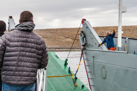 ISLA MAGDALENA, CHILE - MARCH 4, 2015: Ferry with tourists arrives at Penguin colony on Isla...
