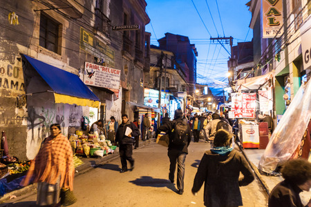 LA PAZ, BOLIVIA - APRIL 23, 2015:  People walk on a night stret in the center of La Paz, Bolivia.のeditorial素材