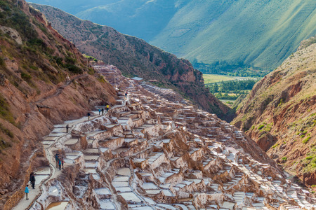 SALINAS, PERU - MAY 21, 2015: Tourists visit salt extraction pans (Salinas) in Sacred Valley of Incas, Peruのeditorial素材