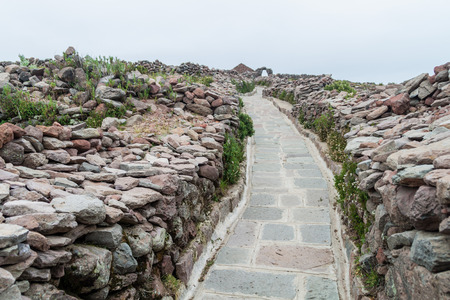 Path leading to Pachamama hill on Amantani island in Titicaca lake, Peruの写真素材