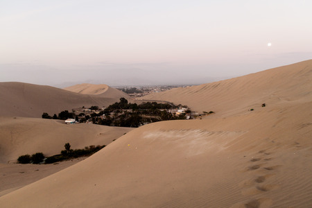 Desert oasis Huacachina near Ica, Peru. Moon visible.の写真素材