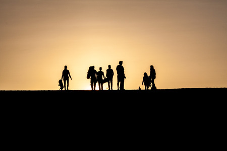 Silhouettes of sand boarders during the sunset near desert oasis Huacachina near Ica, Peruの写真素材