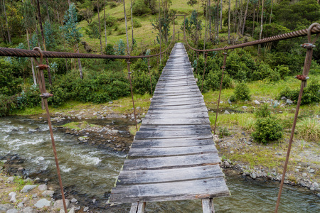 Suspension bridge over Toachi river near Quilotoa crater, Ecuadorの写真素材