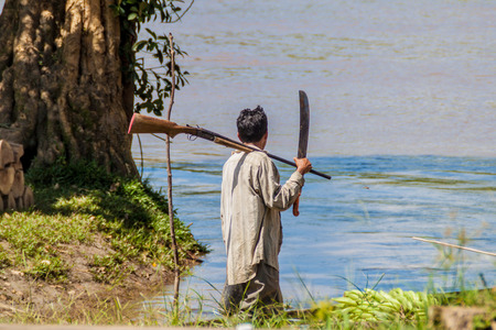 PANTOJA, PERU - JULY 13, 2015: Local hunter on his way to th jungle in Pantoja village, Peru