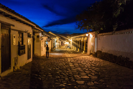 VILLA DE LEYVA, COLOMBIA - SEPTEMBER 21, 2015: Evening moody view of a cobbled street in colonial town Villa de Leyva, Colombia.のeditorial素材