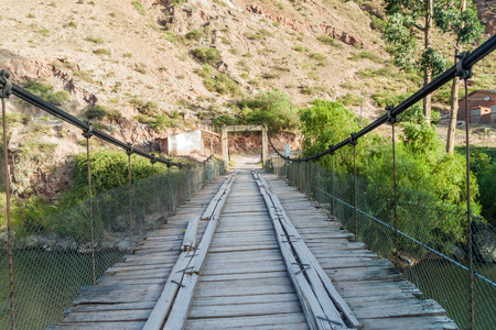 Bridge over Urubamba river in Pichingoto village in Sacred Valley of Incas, Peruの写真素材