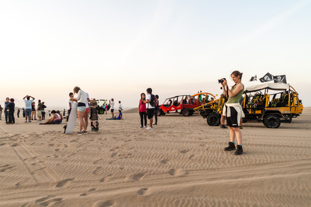 HUACACHINA, PERU - JUNE 1, 2015: Tourists on sand dune buggy trip to the dunes in Huacachina desert, Peruのeditorial素材