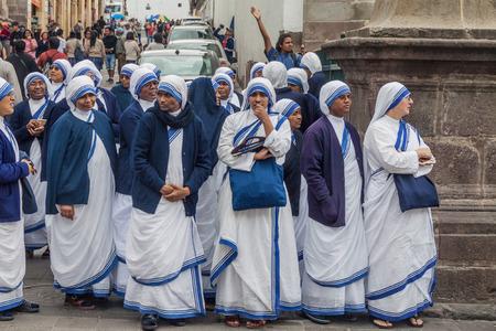 QUITO, ECUADOR - JUNE 24, 2015: Group of nuns in front of  La Compania de Jesus church in old town...