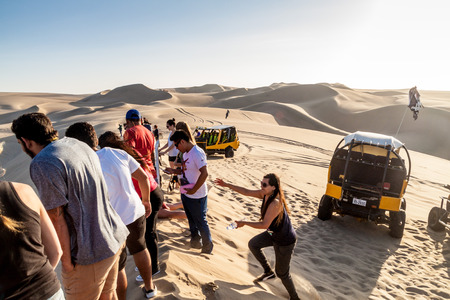HUACACHINA, PERU - JUNE 1, 2015: Tourists on sand dune buggy trip to the dunes in Huacachina desert, Peruのeditorial素材