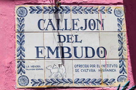 BOGOTA, COLOMBIA - SEPTEMBER 24, 2015: Small graffiti on a street name sign in the La Candelaria neighborhood of Bogota, capital of Colombia.の写真素材
