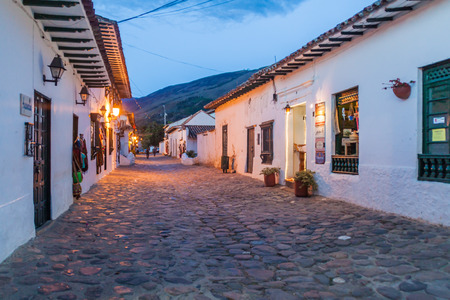 VILLA DE LEYVA, COLOMBIA - SEPTEMBER 21, 2015: Evening moody view of a cobbled street in colonial town Villa de Leyva, Colombia.のeditorial素材