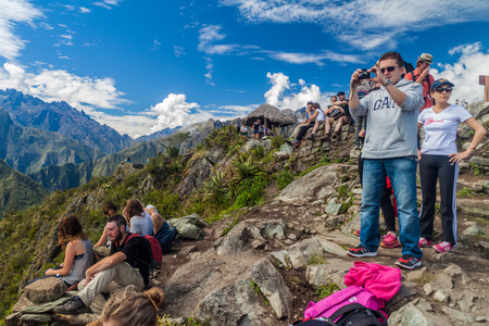 MACHU PICCHU, PERU - MAY 18, 2015: Tourists at the peak of Machu Picchu mountain, Peruのeditorial素材