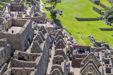 MACHU PICCHU, PERU - MAY 18, 2015: Crowds of visitors at Machu Picchu ruins, Peru.のeditorial素材