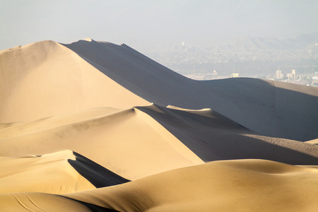 Sand dunes nar Huacachina, Peru. Ica city in the background.の写真素材