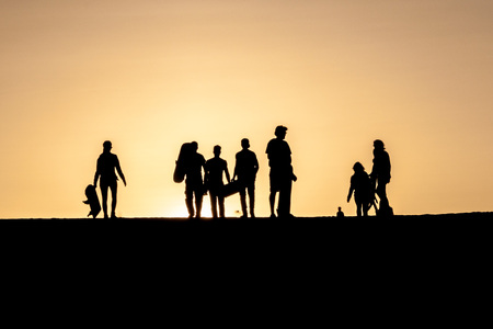 Silhouettes of sand boarders during the sunset near desert oasis Huacachina near Ica, Peruの写真素材