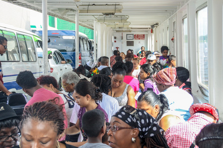 SOUTH DRAIN, SURINAME - AUGUST 9, 2015: People on a ferry crossing Corantijn (Corentyne) river between South Drain in Suriname and Corriverton in Guyana.のeditorial素材