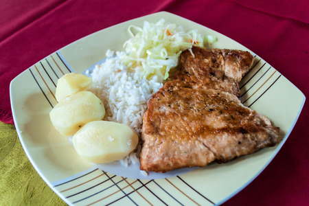 Grilled salmon with rice and potatoes, rastaurant in Ancud, Chileの写真素材