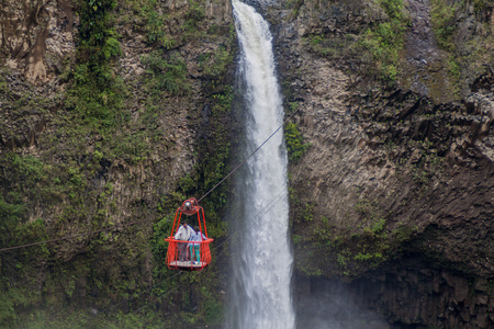 BANOS, ECUADOR - JUNE 22, 2015: Cable car is used for observing Manto de la Novia (Bridal Veil) waterfall near Banos, Ecuadorのeditorial素材